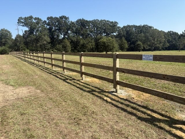 New three-board wood fence along a pasture on Section Road in Covington, LA
